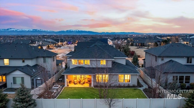 4071 S Twilight Rise Ave, Meridian, ID 83642 - view of front of home with a fenced backyard, a residential view, a mountain view, and roof with shingles
