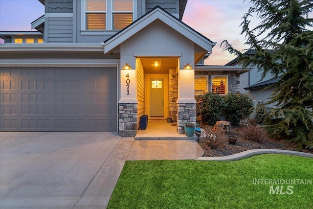 4071 S Twilight Rise Ave, Meridian, ID 83642 - view of front of home featuring stone siding, an attached garage, concrete driveway, and a yard