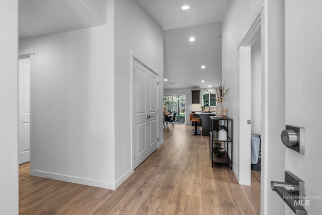 hallway with hardwood / wood-style flooring