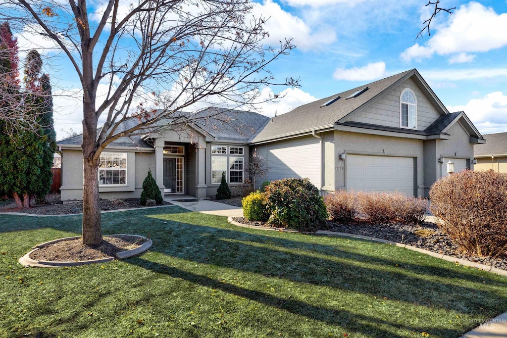 view of front of home with a garage and a front yard