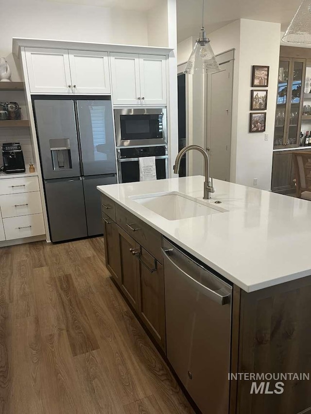 11703 W Amsonia, Star, ID 83669 - kitchen with stainless steel appliances, a sink, dark wood finished floors, and white cabinetry