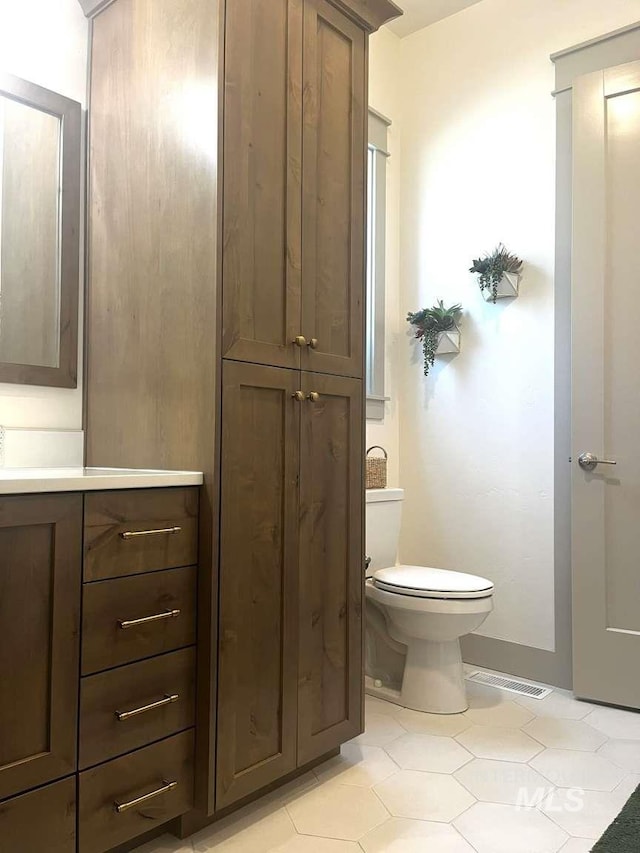 11703 W Amsonia, Star, ID 83669 - half bath with toilet, vanity, and tile patterned flooring