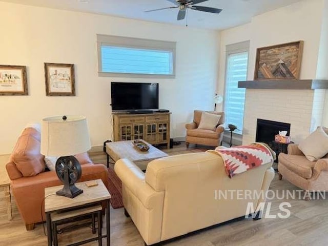 11703 W Amsonia, Star, ID 83669 - living area featuring a ceiling fan, wood finished floors, and a brick fireplace