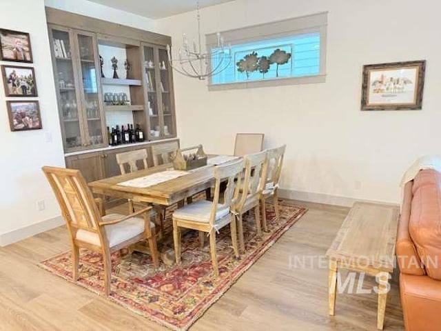 11703 W Amsonia, Star, ID 83669 - dining space with a chandelier, light wood-type flooring, and baseboards