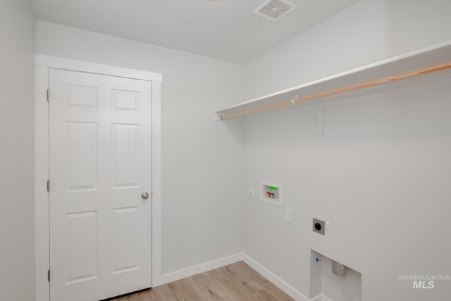 washroom featuring laundry area, visible vents, light wood-style flooring, hookup for an electric dryer, and washer hookup