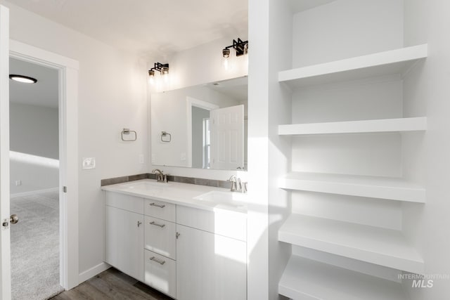 1396 W Malad River St, Meridian, ID 83642 - bathroom with wood finished floors, double vanity, a sink, and baseboards
