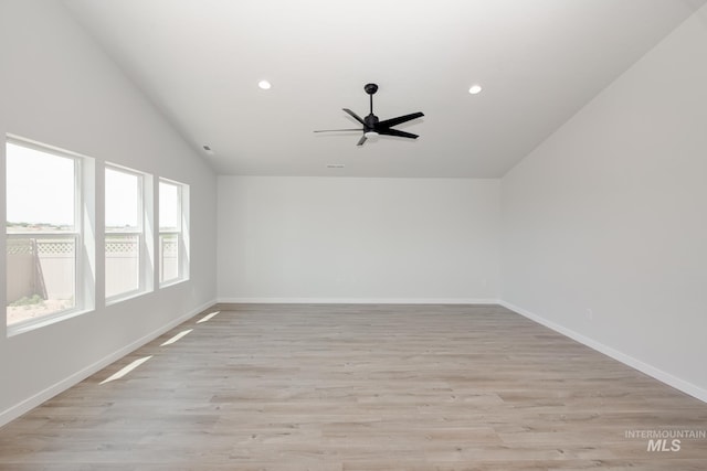 empty room with light wood-style floors, baseboards, vaulted ceiling, and recessed lighting