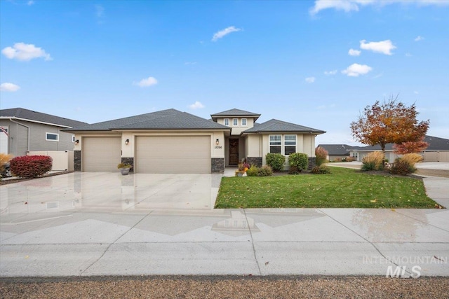 view of front of property with a front lawn and a garage