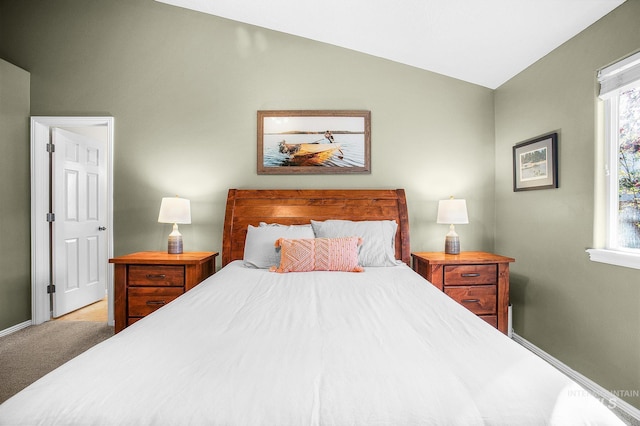 bedroom with carpet flooring and lofted ceiling