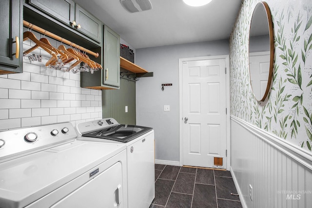 washroom with cabinets and washing machine and clothes dryer