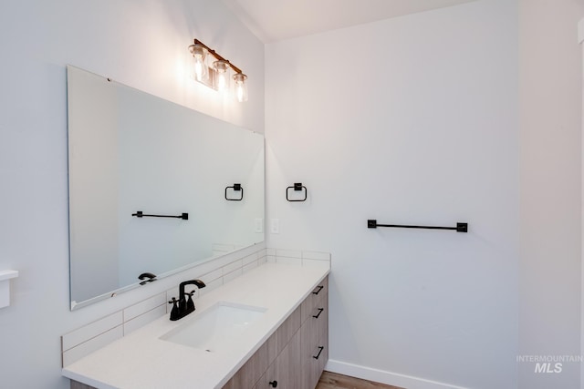 bathroom featuring vanity and baseboards