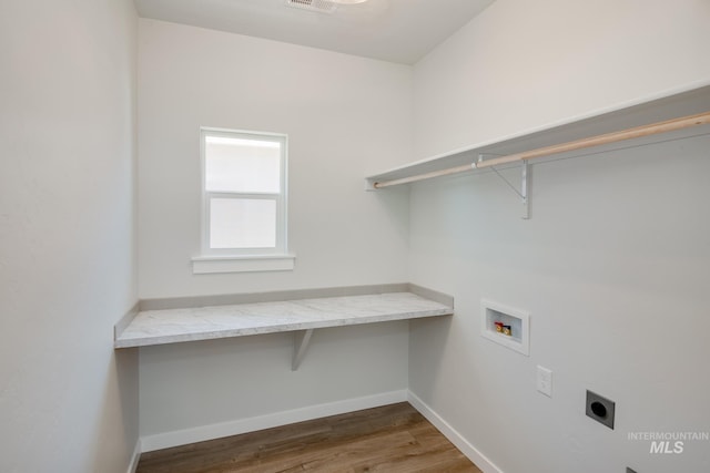 laundry room featuring hookup for an electric dryer, laundry area, dark wood-type flooring, washer hookup, and baseboards