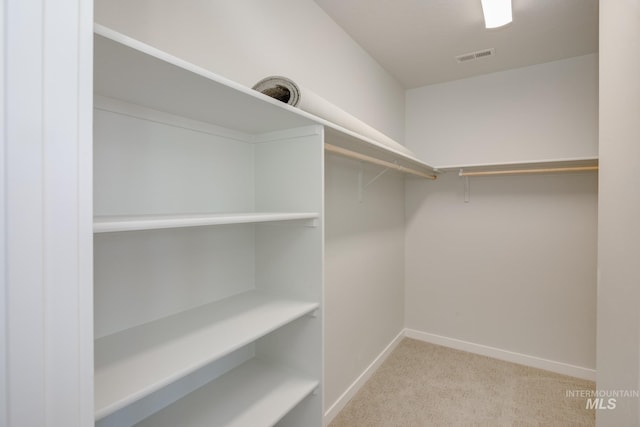 spacious closet featuring light carpet and visible vents