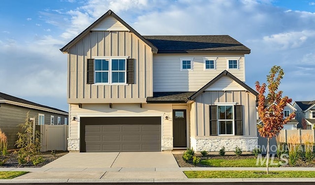11185 W Campanula Ct, Star, ID 83669 - view of front of property with board and batten siding, a garage, driveway, and stone siding