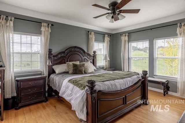 1027 Larkspur, Moscow, ID 83843 - bedroom featuring light wood finished floors, ornamental molding, a ceiling fan, and baseboards