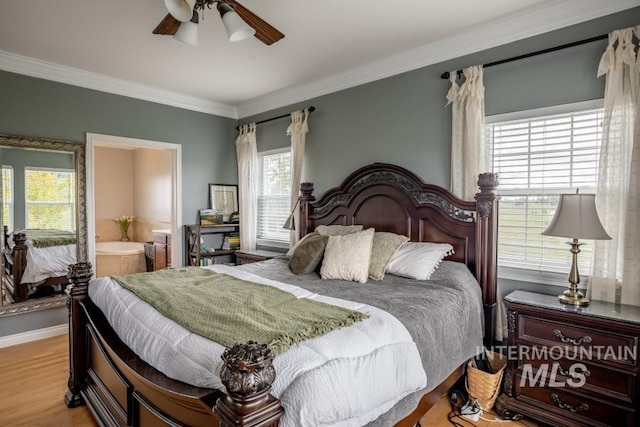 1027 Larkspur, Moscow, ID 83843 - bedroom featuring multiple windows, crown molding, light wood-type flooring, connected bathroom, and a ceiling fan