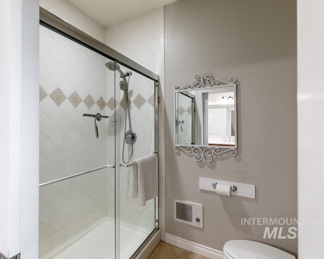 1027 Larkspur, Moscow, ID 83843 - bathroom featuring a shower stall, toilet, and tile patterned floors