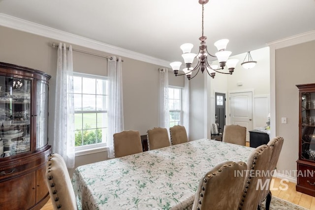 1027 Larkspur, Moscow, ID 83843 - dining space featuring a chandelier, plenty of natural light, crown molding, and light wood-type flooring