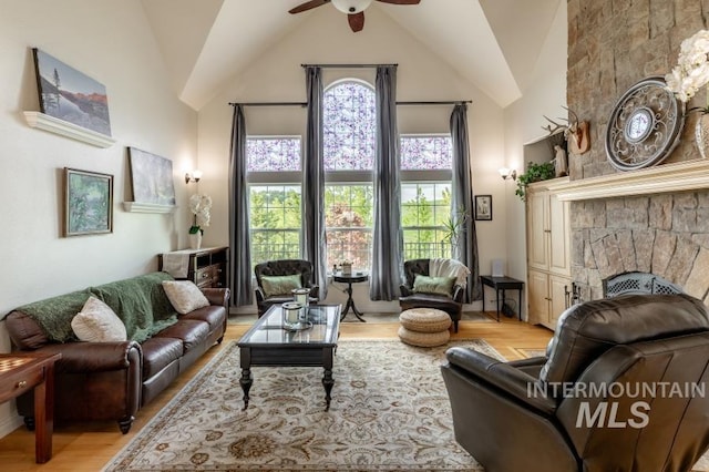 1027 Larkspur, Moscow, ID 83843 - living area featuring a fireplace, ceiling fan, light wood-style floors, and high vaulted ceiling