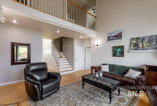 1027 Larkspur, Moscow, ID 83843 - living area with stairs, wood finished floors, a high ceiling, baseboards, and recessed lighting