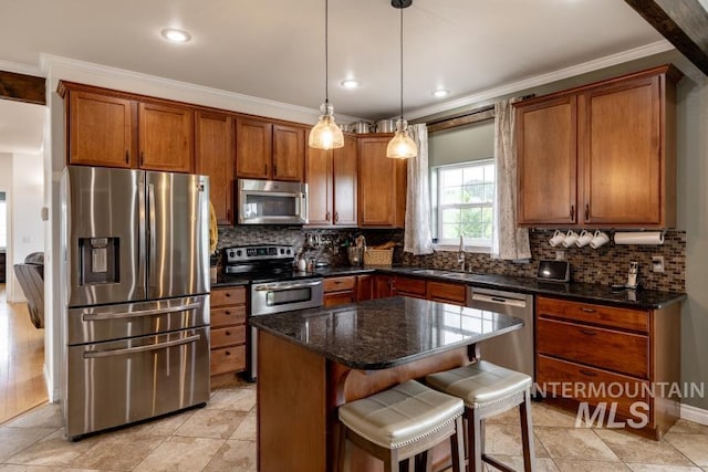 1027 Larkspur, Moscow, ID 83843 - kitchen featuring stainless steel appliances, a sink, brown cabinets, ornamental molding, and decorative backsplash