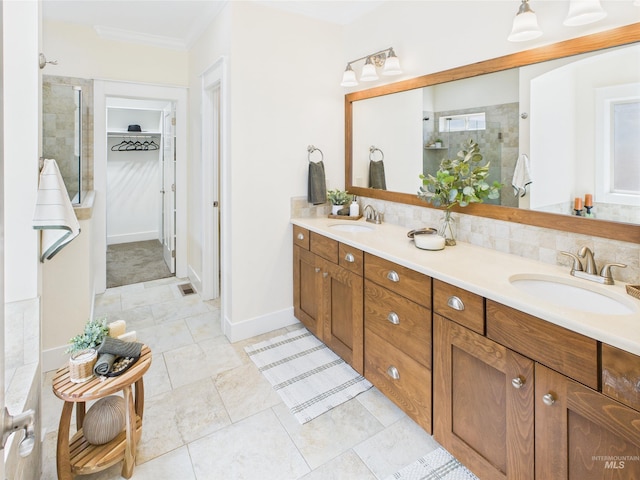 9389 W Wildbranch, Star, ID 83669 - bathroom with tiled shower, double vanity, a walk in closet, ornamental molding, and tile patterned floors