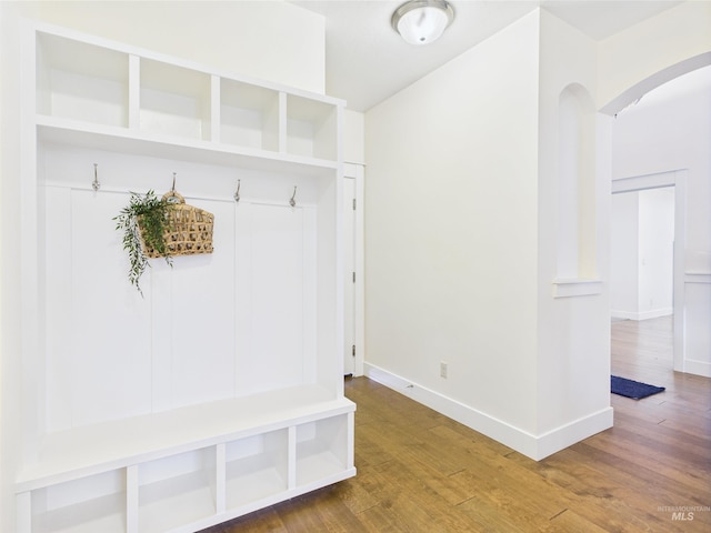 9389 W Wildbranch, Star, ID 83669 - mudroom featuring arched walkways, wood finished floors, and baseboards