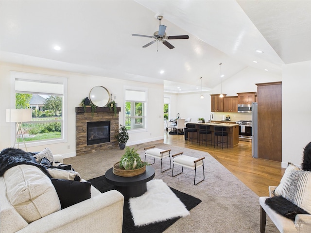 9389 W Wildbranch, Star, ID 83669 - living area with lofted ceiling, a fireplace, ceiling fan, light wood-type flooring, and recessed lighting