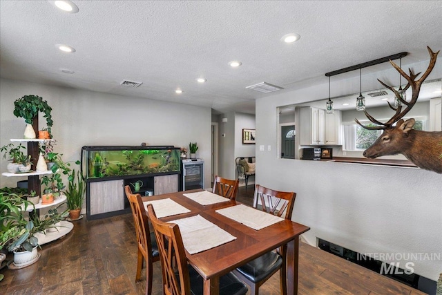 1011 Filer Ave W, Twin Falls, ID 83301 - dining area featuring beverage cooler, hardwood / wood-style floors, recessed lighting, and a textured ceiling