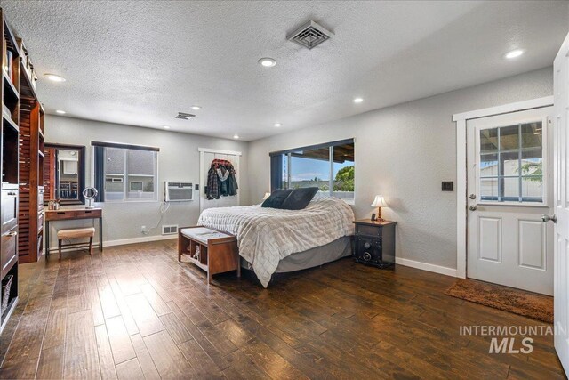 1011 Filer Ave W, Twin Falls, ID 83301 - bedroom featuring dark wood-style floors, baseboards, a textured ceiling, multiple windows, and recessed lighting