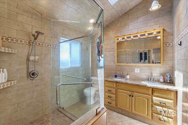 1011 Filer Ave W, Twin Falls, ID 83301 - full bathroom featuring double vanity, a stall shower, lofted ceiling, tile walls, and toilet