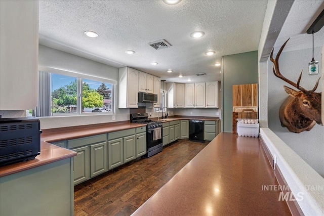 1011 Filer Ave W, Twin Falls, ID 83301 - kitchen featuring stainless steel gas range, green cabinetry, dishwasher, a sink, and white cabinetry