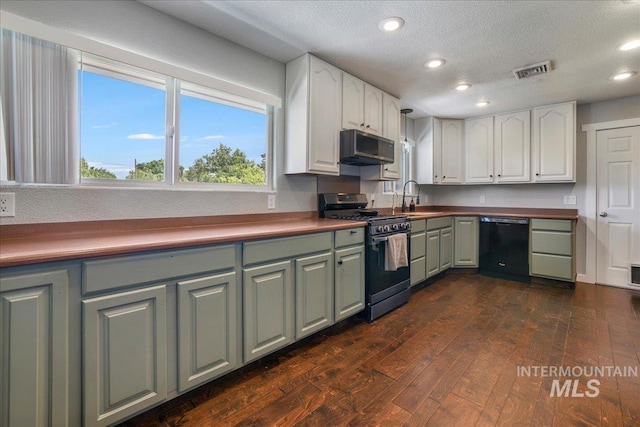 1011 Filer Ave W, Twin Falls, ID 83301 - kitchen featuring appliances with stainless steel finishes, dark wood finished floors, a sink, white cabinetry, and recessed lighting