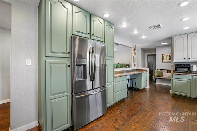 1011 Filer Ave W, Twin Falls, ID 83301 - kitchen with green cabinets, stainless steel refrigerator with ice dispenser, dark wood-style flooring, a textured ceiling, and recessed lighting