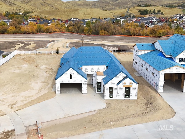 birds eye view of property with a mountain view