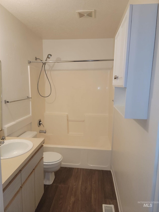 full bathroom featuring visible vents, toilet, bathing tub / shower combination, wood finished floors, and vanity