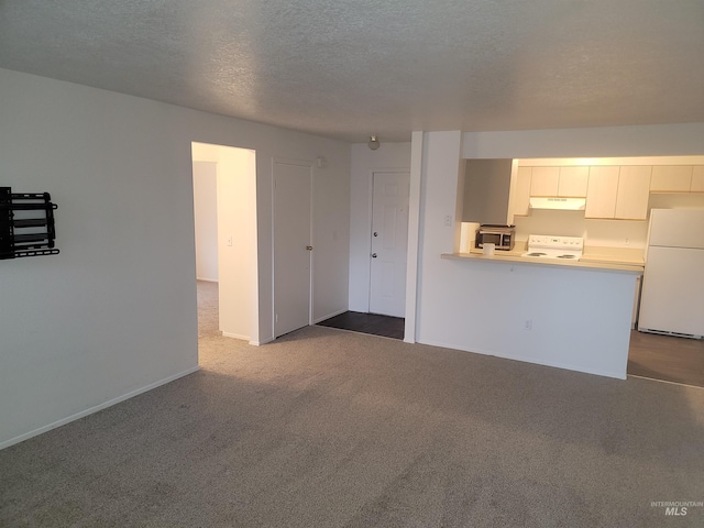 unfurnished living room with dark colored carpet, baseboards, and a textured ceiling