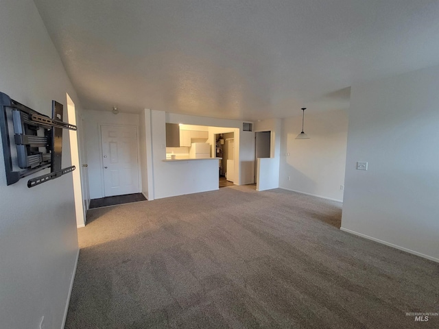 unfurnished living room with baseboards and carpet floors