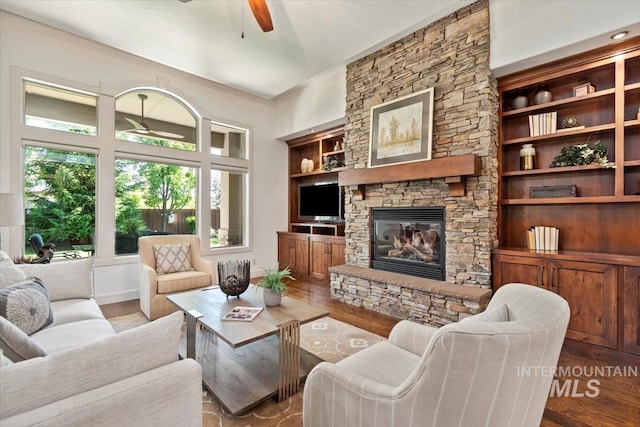 6964 N Moon Drummer Way, Meridian, ID 83646 - living area featuring a ceiling fan, a fireplace, and wood finished floors
