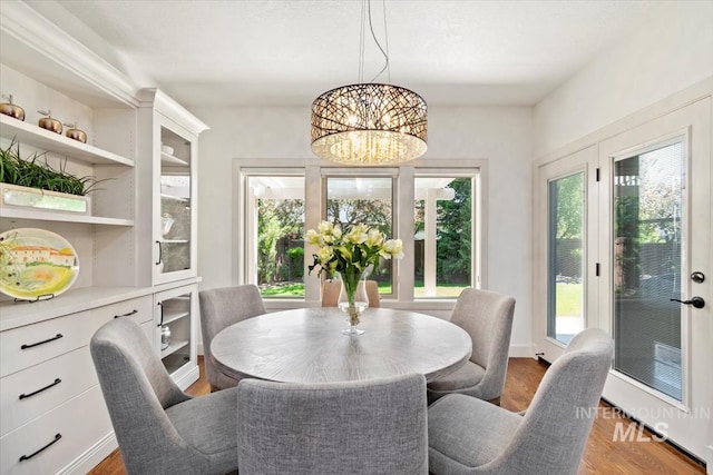 6964 N Moon Drummer Way, Meridian, ID 83646 - dining space with plenty of natural light, a chandelier, and wood finished floors