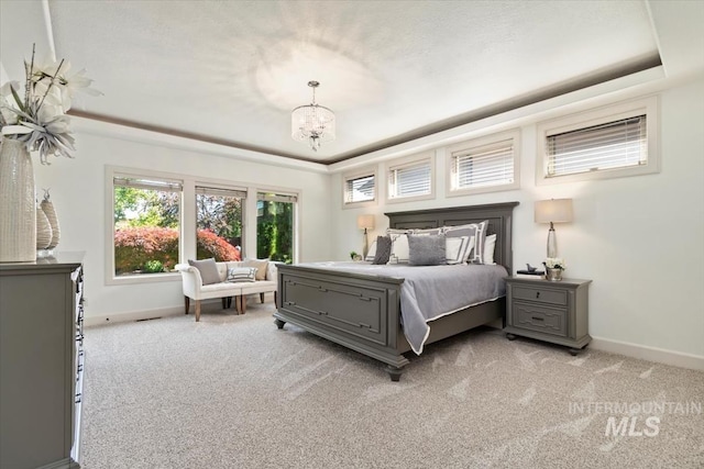 6964 N Moon Drummer Way, Meridian, ID 83646 - bedroom with a raised ceiling, baseboards, and light colored carpet