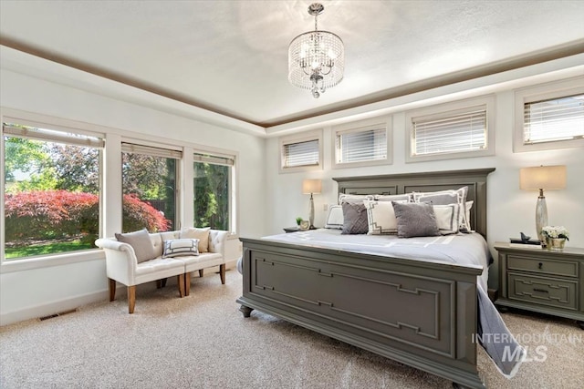 6964 N Moon Drummer Way, Meridian, ID 83646 - bedroom featuring light colored carpet, a chandelier, baseboards, and a tray ceiling