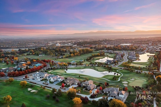 6964 N Moon Drummer Way, Meridian, ID 83646 - aerial view at dusk of a residential view, golf course view, and a water and mountain view