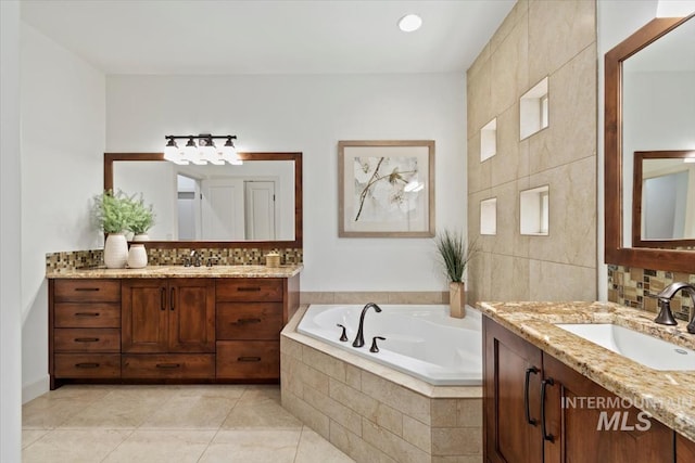 6964 N Moon Drummer Way, Meridian, ID 83646 - bathroom with two vanities, tile patterned floors, a bath, tile walls, and backsplash