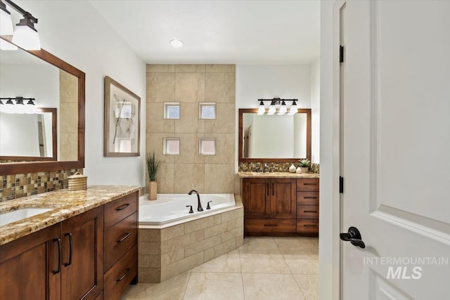 6964 N Moon Drummer Way, Meridian, ID 83646 - full bath featuring two vanities, a bath, tile patterned floors, and tasteful backsplash