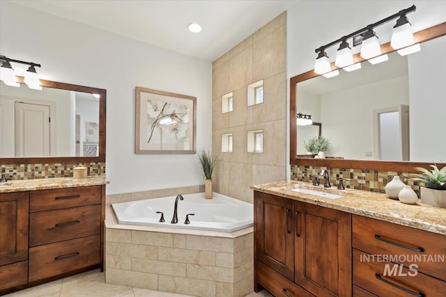 6964 N Moon Drummer Way, Meridian, ID 83646 - bathroom with two vanities, a bath, decorative backsplash, and tile walls