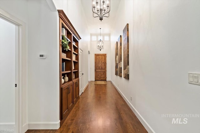6964 N Moon Drummer Way, Meridian, ID 83646 - hall featuring a chandelier, dark wood finished floors, baseboards, and a high ceiling