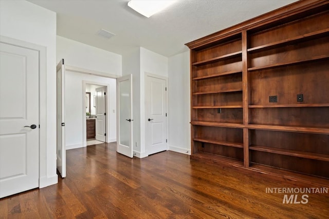 6964 N Moon Drummer Way, Meridian, ID 83646 - unfurnished bedroom featuring dark wood finished floors and baseboards