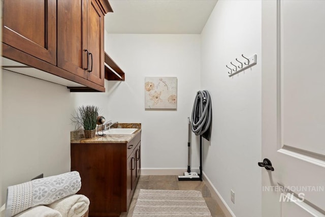 6964 N Moon Drummer Way, Meridian, ID 83646 - laundry area featuring baseboards and cabinet space