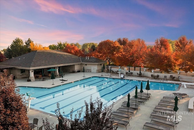 6964 N Moon Drummer Way, Meridian, ID 83646 - pool at dusk featuring a patio area and a community pool
